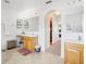 Bright bathroom with double sinks, wood cabinets, an arched hallway, and tile floors at 193 Fish Hawk Dr, Winter Haven, FL 33884