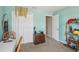 Bedroom with aqua walls, carpet, and decorative accents at 193 Fish Hawk Dr, Winter Haven, FL 33884