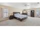 Large carpeted main bedroom with plenty of natural light, two windows, and ensuite bathroom at 193 Fish Hawk Dr, Winter Haven, FL 33884