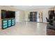 Expansive bonus room featuring tile floors, a large TV, and mirrored sliding doors to the lanai at 193 Fish Hawk Dr, Winter Haven, FL 33884