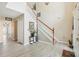 The foyer features laminate flooring, a staircase, and stylish decor, creating a welcoming entrance to the home at 193 Fish Hawk Dr, Winter Haven, FL 33884