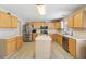 Bright kitchen features an island, stainless steel appliances, and wood cabinets, perfect for cooking at 193 Fish Hawk Dr, Winter Haven, FL 33884