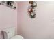 Charming powder room features unique butterfly wall art and glass shelving at 193 Fish Hawk Dr, Winter Haven, FL 33884