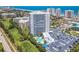 Stunning aerial view of a high-rise condo building with a pool, golf course, and ocean views at 2 Oceans West Blvd # 1007, Daytona Beach, FL 32118
