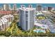 Stunning aerial view of white beachfront condo with balconies, swimming pool and lush landscaping near the ocean at 2 Oceans West Blvd # 1007, Daytona Beach, FL 32118