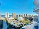 Balcony view of city buildings, ocean, and recreational area with parking at 2 Oceans West Blvd # 1007, Daytona Beach, FL 32118