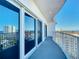 Private balcony with ocean view offers a peaceful retreat with sliding glass doors and white railings at 2 Oceans West Blvd # 1007, Daytona Beach, FL 32118