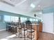 Clubhouse bar with countertop, cabinets, barstools, lots of light from large windows and a huge mirror behind at 2 Oceans West Blvd # 1007, Daytona Beach, FL 32118