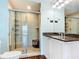 Bathroom featuring a shower with glass door, vanity with granite countertop, and ample cabinet space at 2 Oceans West Blvd # 1007, Daytona Beach, FL 32118