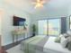 Inviting bedroom with a slider to the outdoor balcony, neutral tones, and serene ocean views at 2 Oceans West Blvd # 1007, Daytona Beach, FL 32118