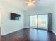 Bright bedroom with a sliding glass door leading to a balcony with ocean views at 2 Oceans West Blvd # 1007, Daytona Beach, FL 32118