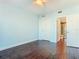 This bedroom features hardwood floors, a ceiling fan, and an ensuite bathroom with glass shower at 2 Oceans West Blvd # 1007, Daytona Beach, FL 32118