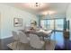 Open-concept living and dining area with dark wood floors and large windows offering ocean views at 2 Oceans West Blvd # 1007, Daytona Beach, FL 32118