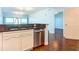 Eat-in kitchen featuring stainless steel dishwasher, granite countertops, and white cabinetry at 2 Oceans West Blvd # 1007, Daytona Beach, FL 32118