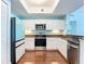 Modern kitchen featuring stainless steel appliances, granite countertops, and white cabinetry at 2 Oceans West Blvd # 1007, Daytona Beach, FL 32118