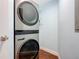 Efficient laundry area features a stacked washer and dryer set and well-lit blue walls at 2 Oceans West Blvd # 1007, Daytona Beach, FL 32118
