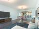 Bright living room showcasing an open floor plan, modern decor, and a view into the dining room at 2 Oceans West Blvd # 1007, Daytona Beach, FL 32118