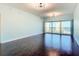 Spacious living room with hardwood floors, modern lighting and sliding glass doors at 2 Oceans West Blvd # 1007, Daytona Beach, FL 32118