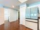 Open-concept living space with hard wood flooring and view to the hallway and entry to a bathroom at 2 Oceans West Blvd # 1007, Daytona Beach, FL 32118