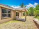 The house boasts a backyard featuring a covered patio area and neat landscaping at 200 S Montgomery Ave, Deland, FL 32720
