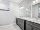 Modern bathroom with dual vanities, granite countertops, and a walk-in shower with glass door at 200 S Montgomery Ave, Deland, FL 32720