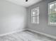 Bedroom with tile flooring and two windows bringing in natural light at 200 S Montgomery Ave, Deland, FL 32720