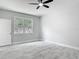 Clean bedroom with neutral paint, tile flooring, a ceiling fan, and a sunny window at 200 S Montgomery Ave, Deland, FL 32720