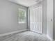 Cozy bedroom features tile floors, a closet with double doors, and a window to let in natural light at 200 S Montgomery Ave, Deland, FL 32720