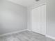 Bedroom featuring white closet doors, base molding, and tile floors at 200 S Montgomery Ave, Deland, FL 32720
