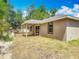 Exterior view of the home showcasing the backyard, patio, and lush landscaping at 200 S Montgomery Ave, Deland, FL 32720