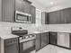 Modern kitchen featuring stainless steel appliances, granite countertops, and ample cabinet space at 200 S Montgomery Ave, Deland, FL 32720