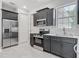 Kitchen features stainless steel appliances, dark cabinetry, and tile flooring at 200 S Montgomery Ave, Deland, FL 32720