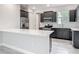 Well-equipped kitchen featuring stainless steel appliances, gray cabinets, and granite countertops at 200 S Montgomery Ave, Deland, FL 32720