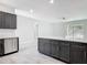 Open concept kitchen with gray cabinets, stainless steel appliances, and an eat-in island at 200 S Montgomery Ave, Deland, FL 32720