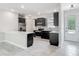 Stylish kitchen features stainless steel appliances, gray cabinets, and an eat-in island at 200 S Montgomery Ave, Deland, FL 32720
