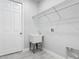 Functional laundry room with a utility sink, wire shelving, and tile flooring at 200 S Montgomery Ave, Deland, FL 32720