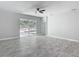 Open living room with sliding glass doors to patio and modern ceiling fan at 200 S Montgomery Ave, Deland, FL 32720