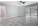 Open living room with sliding glass doors to patio with modern ceiling fan at 200 S Montgomery Ave, Deland, FL 32720
