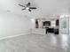 Open-concept living area with tile flooring and a view of the kitchen featuring dark wood cabinets at 200 S Montgomery Ave, Deland, FL 32720