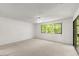 Bright bedroom with carpeted floors and large windows offering backyard views at 207 Pine Cone Trl, Ormond Beach, FL 32174