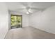 A bedroom with a sliding glass door that leads to a balcony at 207 Pine Cone Trl, Ormond Beach, FL 32174
