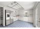 Bright kitchen with white cabinetry, stainless steel appliances, and a blue tiled floor at 207 Pine Cone Trl, Ormond Beach, FL 32174