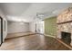 Spacious living room featuring hardwood floors, fireplace, and ample natural light at 207 Pine Cone Trl, Ormond Beach, FL 32174