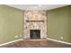 Cozy living room highlighting a stone fireplace and neutral wall paint at 207 Pine Cone Trl, Ormond Beach, FL 32174