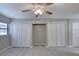 Bright bedroom features a ceiling fan and closet doors at 2100 Ocean Shore Blvd # 1120, Ormond Beach, FL 32176