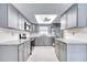 Contemporary kitchen design with sleek appliances, stylish gray cabinetry, and bright lighting at 2100 Ocean Shore Blvd # 1120, Ormond Beach, FL 32176