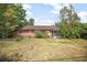 View of the house and backyard showcasing the lawn and screened patio at 2126 Sabal Palm Dr, Edgewater, FL 32141