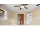 Bright bedroom with tile flooring, closet, ceiling fan and a view to the outside at 2126 Sabal Palm Dr, Edgewater, FL 32141