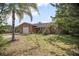 Charming single-story home with brick exterior, well-manicured lawn and mature trees at 2126 Sabal Palm Dr, Edgewater, FL 32141