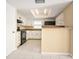 Functional kitchen featuring white cabinets, black appliances, and tile floors at 2126 Sabal Palm Dr, Edgewater, FL 32141